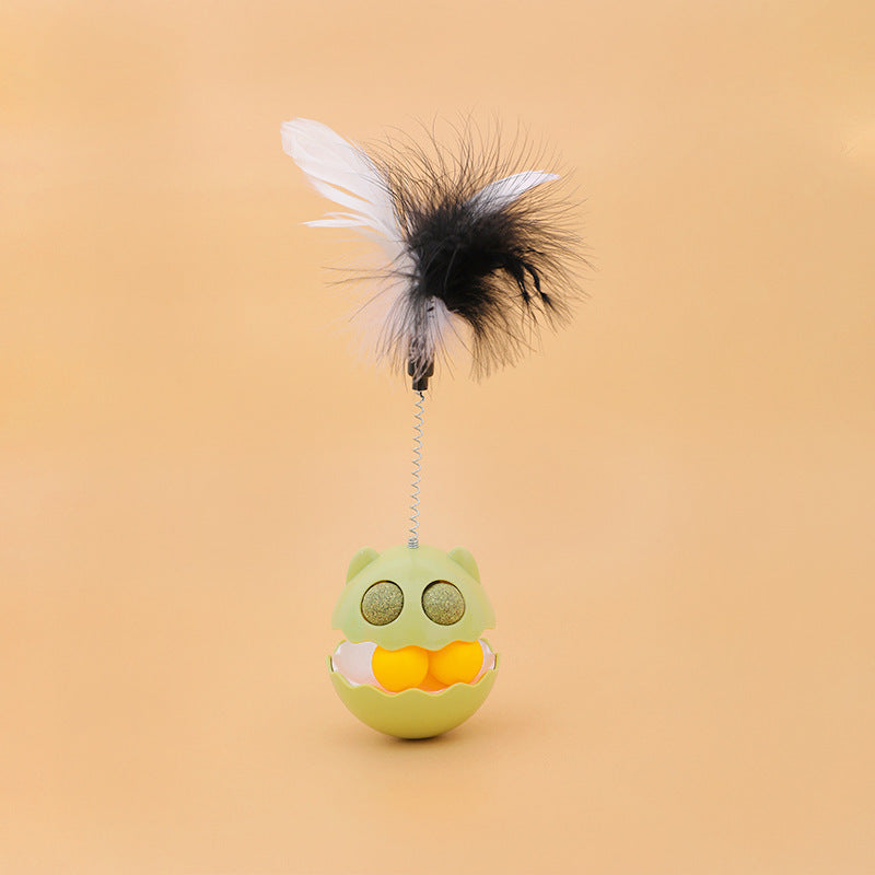 Rotating feather cat toy with interactive tumbler roller, catnip-filled balls, and attached black and white feathers