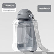 Gray 2-in-1 dog water bottle with integrated bowl and carry strap, large 1000ml capacity portable pet dispenser.