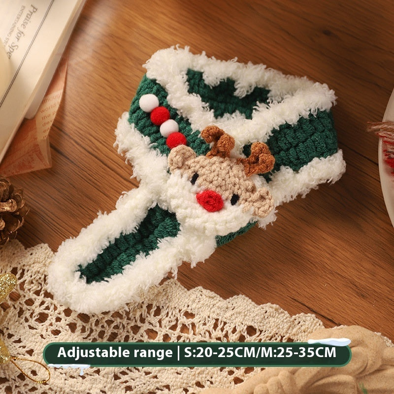 Green and white wool pet scarf with a reindeer decoration, designed for cats and dogs, adjustable size for winter use.