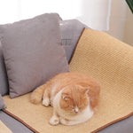 Load image into Gallery viewer, Orange and white cat resting comfortably on a durable sisal cat scratch mat placed on gray sofa cushions
