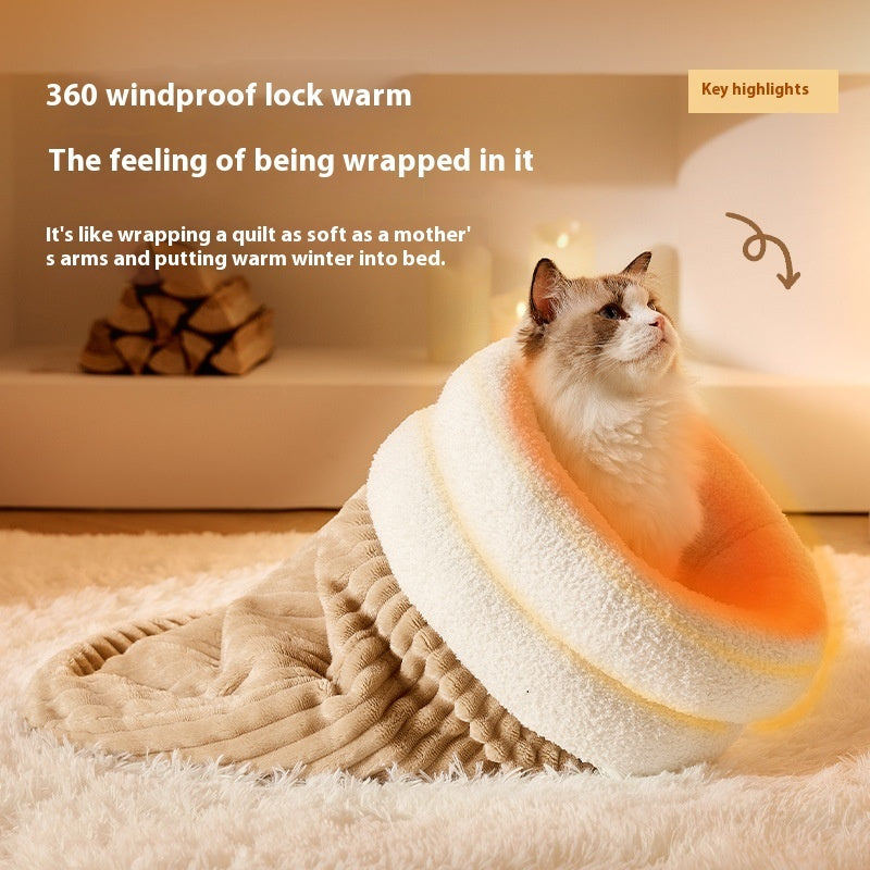 Cat sitting inside a warm, plush, semi-enclosed pet sleeping bag with soft velvet and lambswool lining.