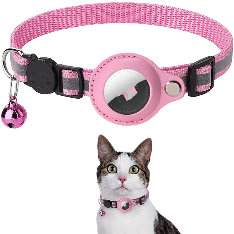 Pink reflective nylon pet collar with waterproof AirTag holder and bell, shown on a cat, adjustable for cats and dogs