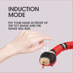 Load image into Gallery viewer, Hand triggering red and black interactive electric snake cat toy to activate induction mode and make it move.
