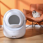 Load image into Gallery viewer, Smart automatic cat litter box with app control and self-cleaning 10L drawer next to a cat on an orange chair

