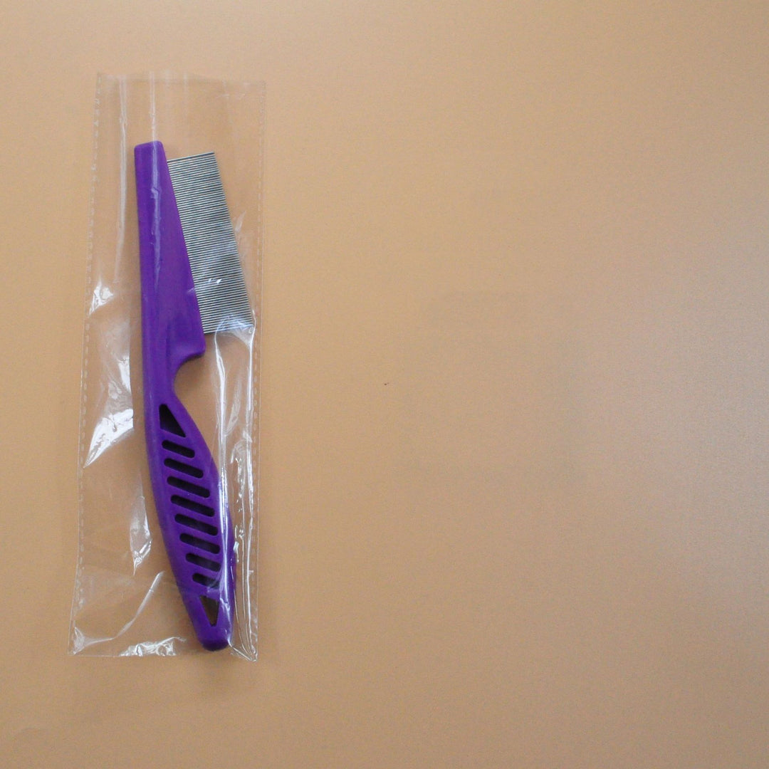 Purple pet grooming flea comb in clear plastic wrap, fine tooth stainless steel comb for flea and tangle removal.