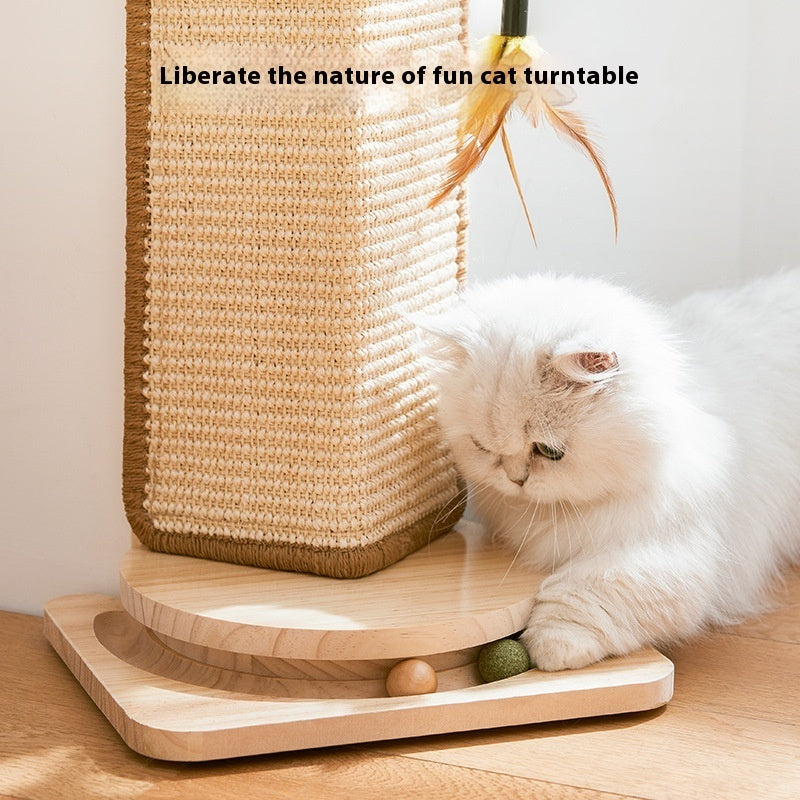 White cat playing with corner cat scratch board featuring a wooden base and feather toy attachment indoors