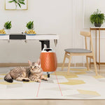 Load image into Gallery viewer, Cat lying next to an automatic smart massager and pet hair brush with sensor on a modern living room floor.
