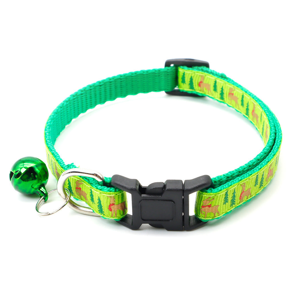 Green Christmas pet collar with festive tree and reindeer pattern and attached holiday bell for dogs or cats