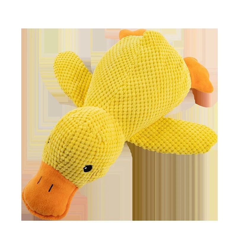 Yellow plush duck dog toy with orange beak and feet designed as a calming chew pillow for puppies and dogs