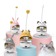 Set of four animal-themed tumbler leaky ball treat toys for cats and dogs with a curious cat nearby