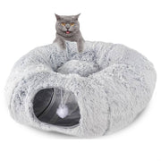 Gray cat sitting on a foldable plush winter cat tunnel nest with a small hanging toy inside the soft kennel