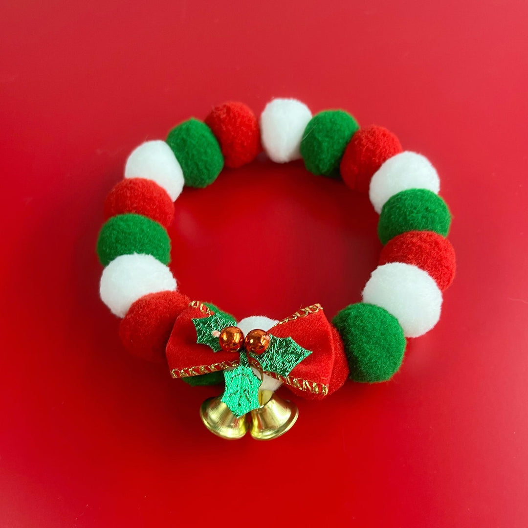 Christmas pet collar with red, green, white plush balls, festive bow, and gold jingle bells for dogs and cats