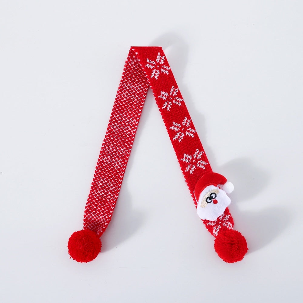 Red knitted wool pet scarf with white snowflake pattern and a small Santa Claus decoration for holiday pets.