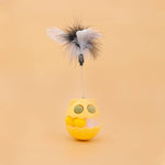 Load image into Gallery viewer, Yellow rotating cat toy with feathers and spring, designed for interactive play with catnip and a track ball inside
