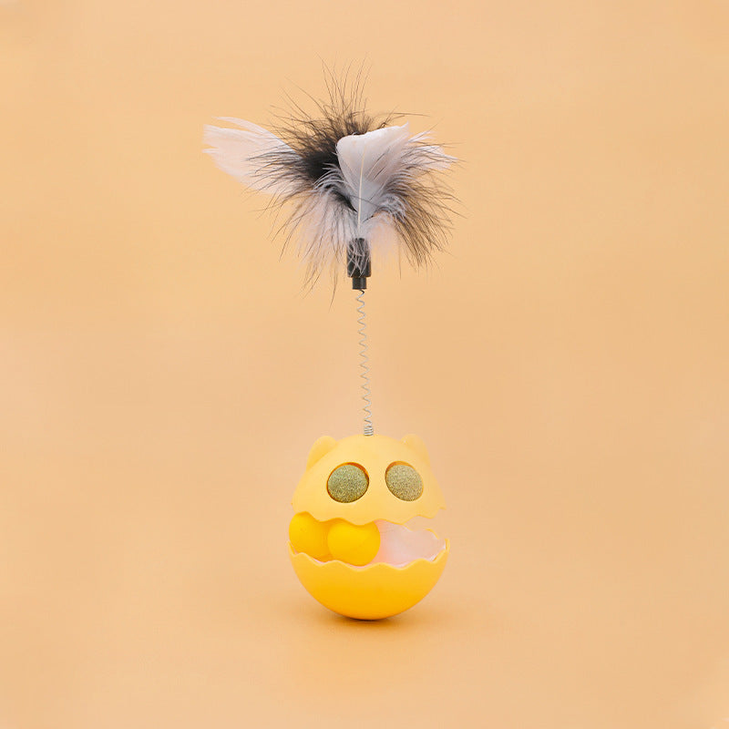 Yellow rotating cat toy with feathers and spring, designed for interactive play with catnip and a track ball inside