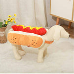 Load image into Gallery viewer, Dog wearing a funny hot dog costume with red ketchup and yellow mustard for Halloween or party dress-up.
