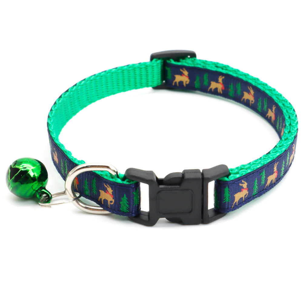 Green festive pet collar with cartoon reindeer and trees pattern and a green Christmas bell attached