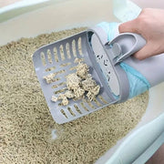 Upgraded Cat Litter Poop Picker with Trash Bin & Shovel scooping clumped litter from a cat litter box using integrated shovel and bin design.