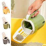 Load image into Gallery viewer, User scooping cat litter into green integrated scoop and bin system with built-in waste bag for mess-free and odor-controlled cleaning.

