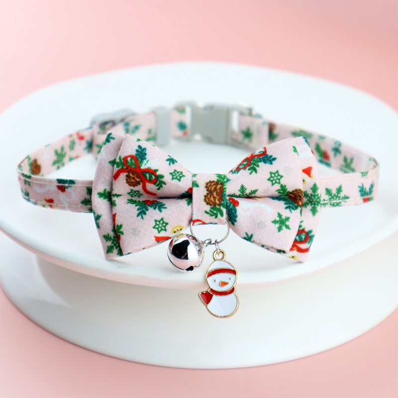 Adjustable Christmas pet collar with festive bow tie, holiday prints, jingle bell, and snowman charm for dogs and cats