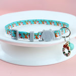 Load image into Gallery viewer, Adjustable blue Christmas pet collar with festive Santa and reindeer prints and cat-shaped buckle with holiday charm accessory
