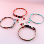 Load image into Gallery viewer, Four adjustable polyester Christmas pet collars with festive charms and bells on a pink background
