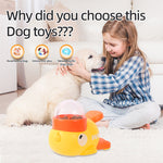 Load image into Gallery viewer, Young girl sitting with a golden retriever puppy and a yellow interactive duck-shaped dog puzzle feeder toy on carpet

