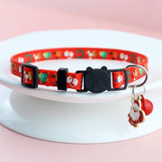 Adjustable red Christmas pet collar with festive Santa prints, black cat-shaped buckle, and holiday bow tie charm for dogs and cats