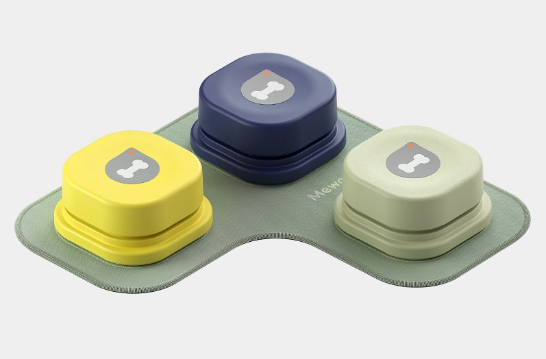 Three colorful recordable talking buttons for dogs and cats on a green base with bone icons on top