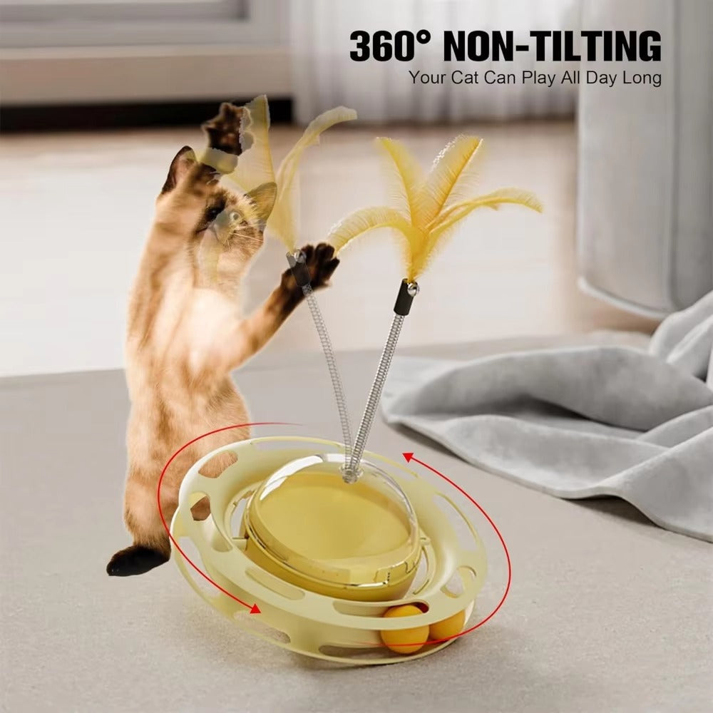 Cat playing with 360-degree non-tilting tumbler toy featuring turntable feathers and dental play balls