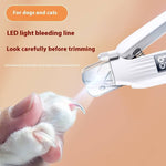 Load image into Gallery viewer, Close-up of a pet nail clipper with LED light trimming a dog&#39;s or cat&#39;s nail safely and precisely
