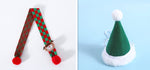 Load image into Gallery viewer, Knitted wool plaid red and green pet scarf with pompom and elf face, and green Santa Claus hat with white trim and pompom.
