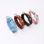 Adjustable leather pet collars with protective Airtag covers in blue, brown, green, and pink for cats and dogs tracking.