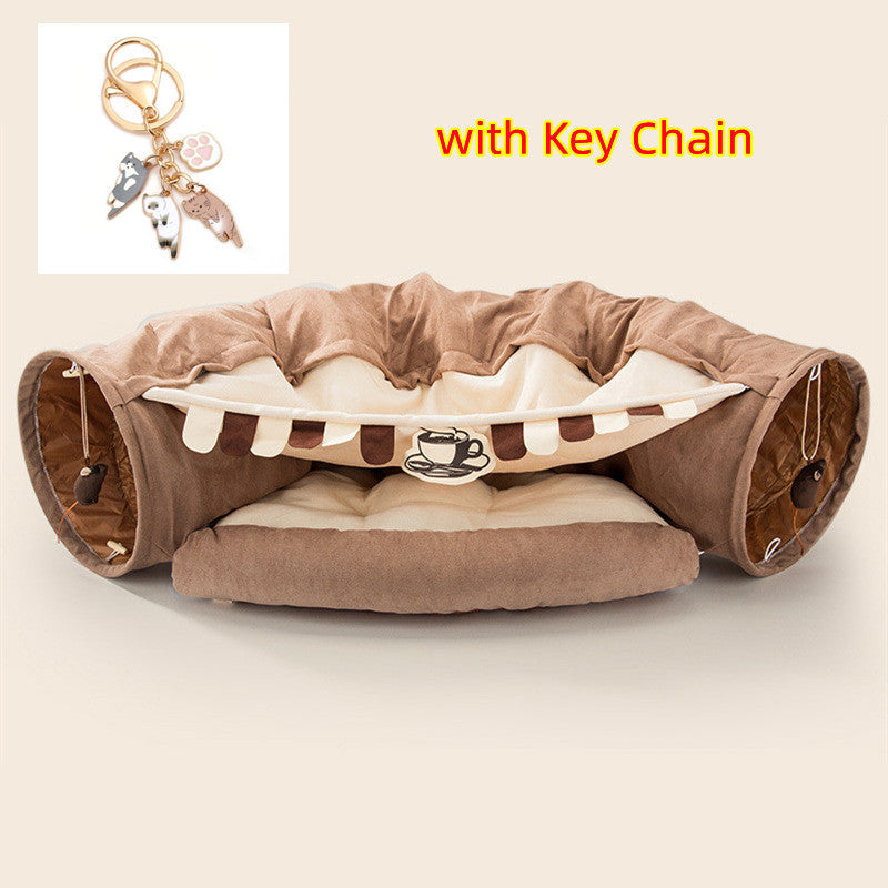 Brown and cream collapsible cat tunnel with soft cushion and hanging mouse toys, includes cat-themed keychain accessory.