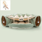 Load image into Gallery viewer, Collapsible green cat tunnel with soft cushion, hanging pom-pom toys, and washable durable fabric for interactive play.
