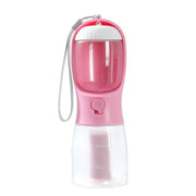 Portable pink 3-in-1 dog water bottle with feeder, waste bag dispenser, and bowl for travel and outdoor use.