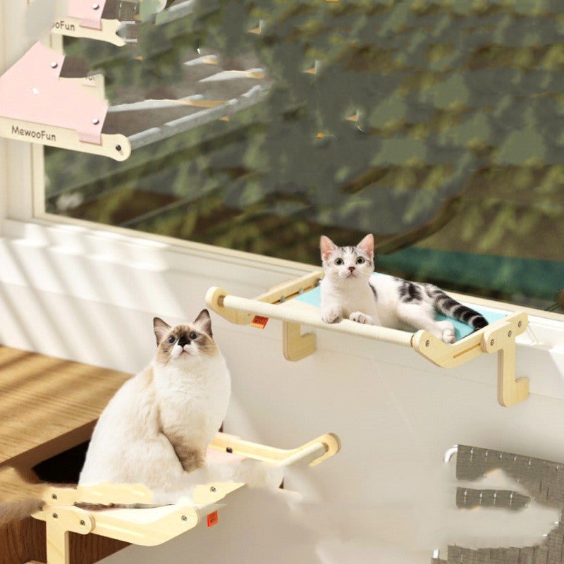 Two cats resting on space-saving hanging beds attached to a window for cozy perch and relaxation