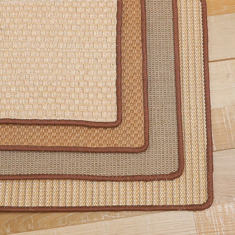 Stacked durable sisal cat scratch mats with brown edging on wooden floor background