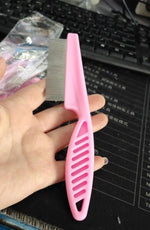 Load image into Gallery viewer, Pink fine tooth flea comb for pets shown in hand, ergonomic handle and stainless steel teeth for flea and tangle removal.