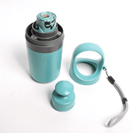 Load image into Gallery viewer, Portable six-claw dog pooper scooper in teal with storage container, dispenser, and carrying handle strap on white background.
