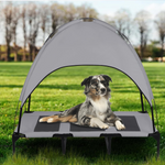 Load image into Gallery viewer, Dog resting on elevated pet bed with breathable mesh and attached summer shade canopy outdoors on grass
