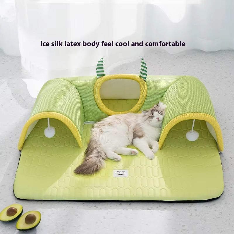 Cat resting on a green breathable cat tunnel bed with soft padded ice silk latex surface and playful hanging toys.