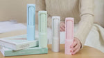 Load and play video in Gallery viewer, Pastel-colored 2-in-1 Pet Hair Remover Brushes on books and table. Eco-friendly, reusable lint rollers ideal for pet fur on clothes and furniture.
