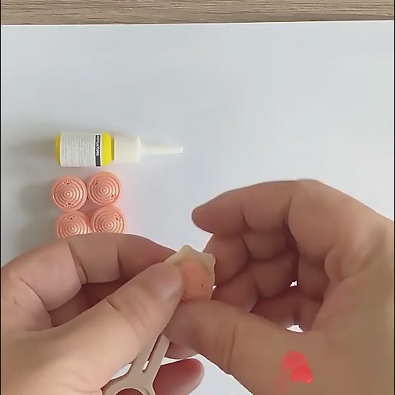 Hands assembling pink repellent inserts into the POT N PET™ flea and tick collar for pets, showing easy setup for pest protection.